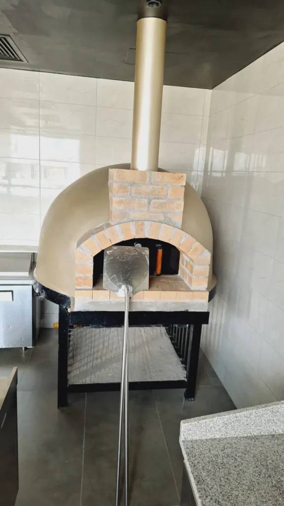 Precast dome pizza oven installed in a restaurant kitchen